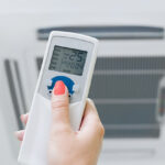 a woman clicking on an air condition remote