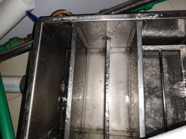 Top view of a dirty grease trap with water flowing in stock photo