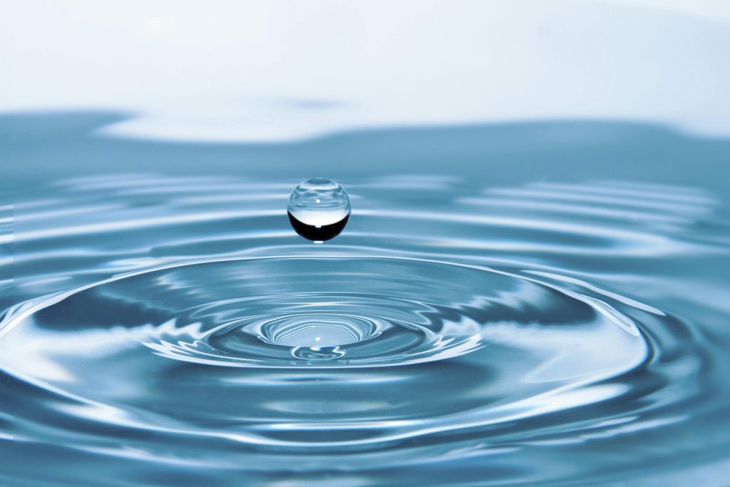 water drop falling into more water
